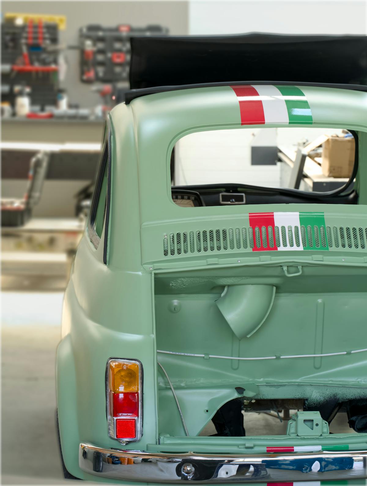 A vintage roadster body in a workshop — the spirit of the Mk4 build.