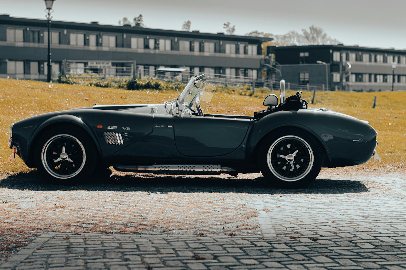 A Factory-Five-style Cobra roadster in deep teal — the kind of build @scottsrides documents.